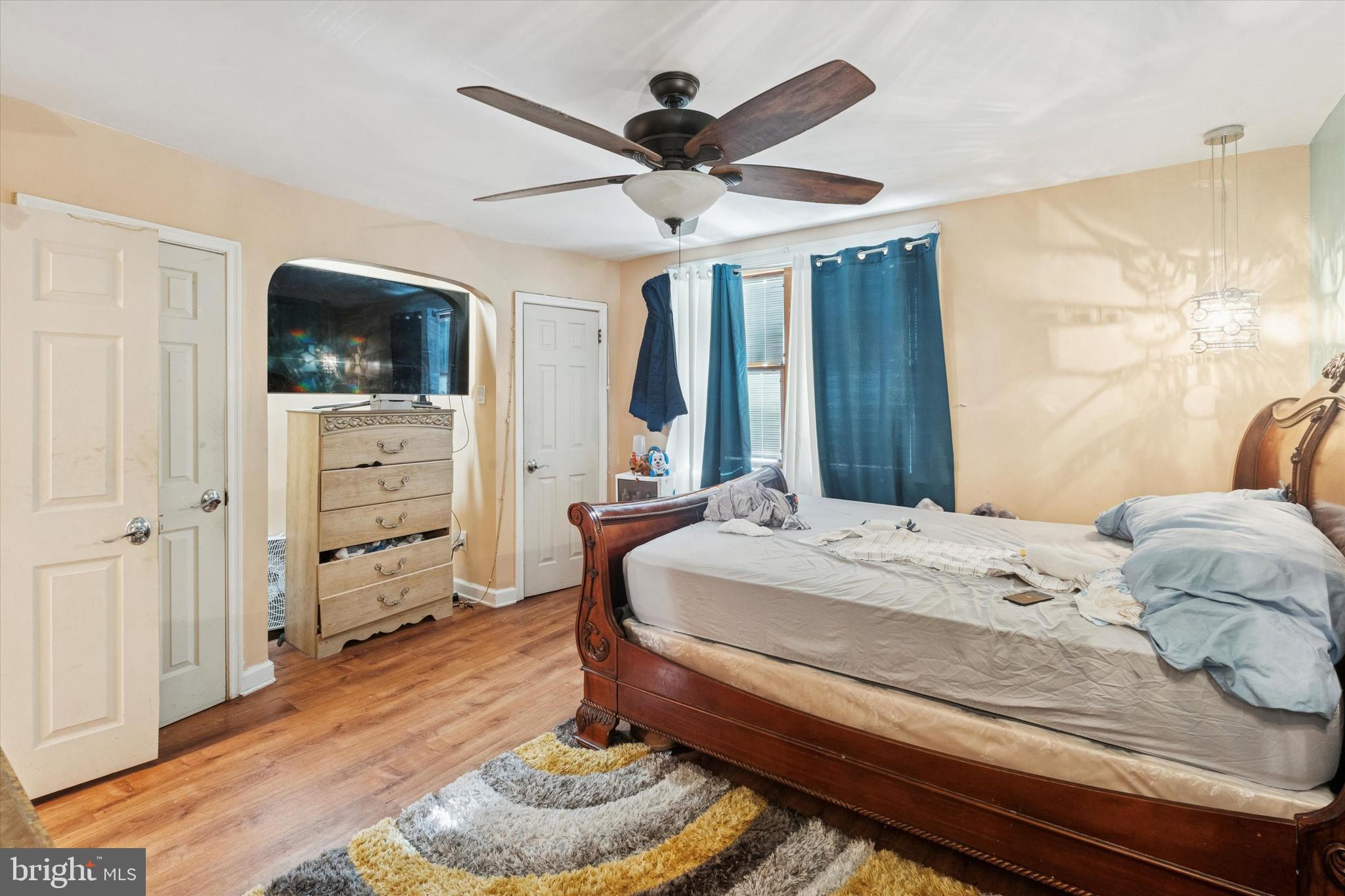 213 East Claremont Road Philadelphia, PA 19120 - Photo 17 of 25 a bedroom with a bed and a flat screen tv