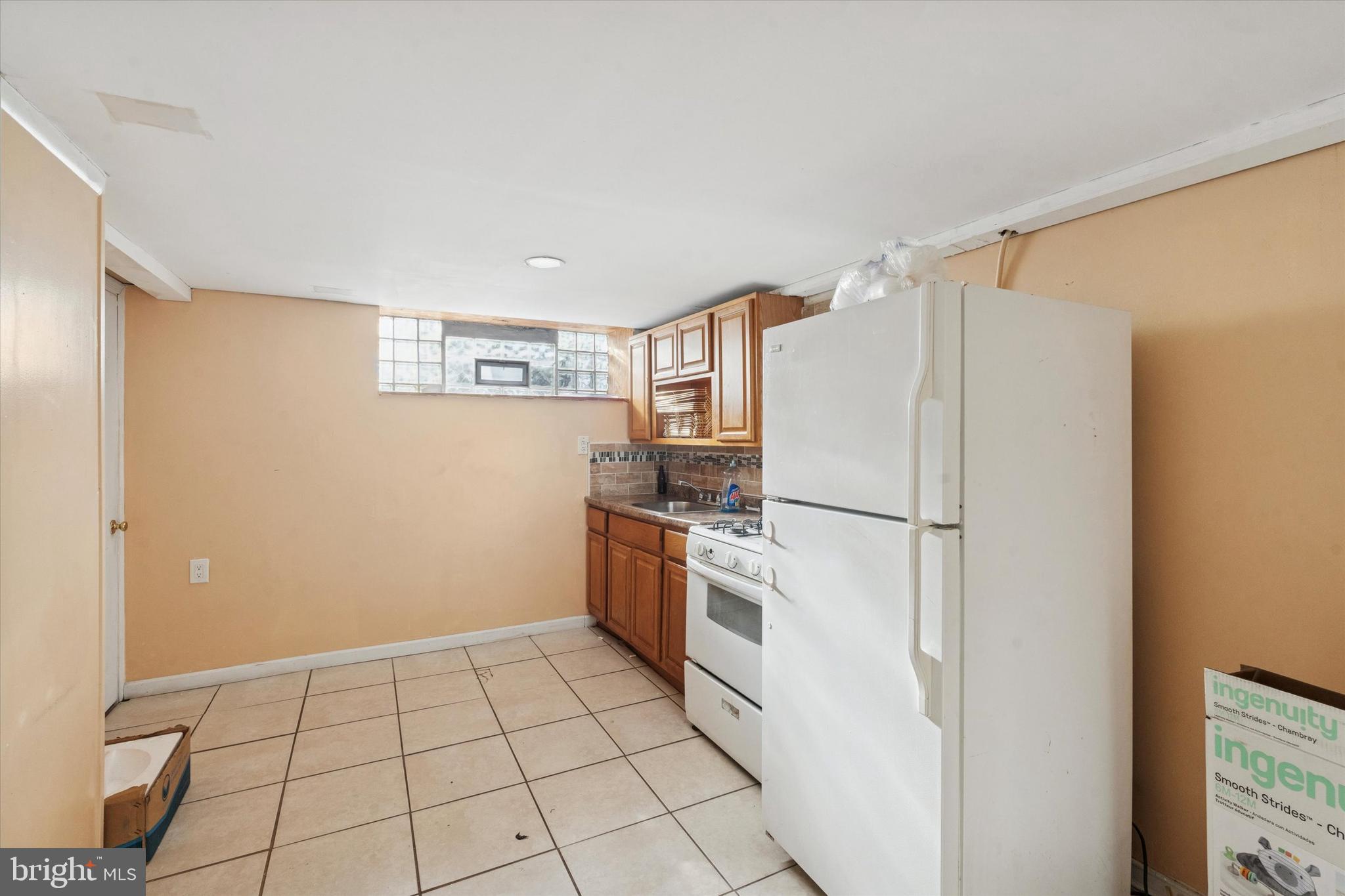 213 East Claremont Road Philadelphia, PA 19120 - Photo 19 of 25 a kitchen with stainless steel appliances a refrigerator sink and cabinets