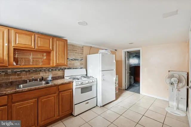 a kitchen with a stove a sink and a refrigerator