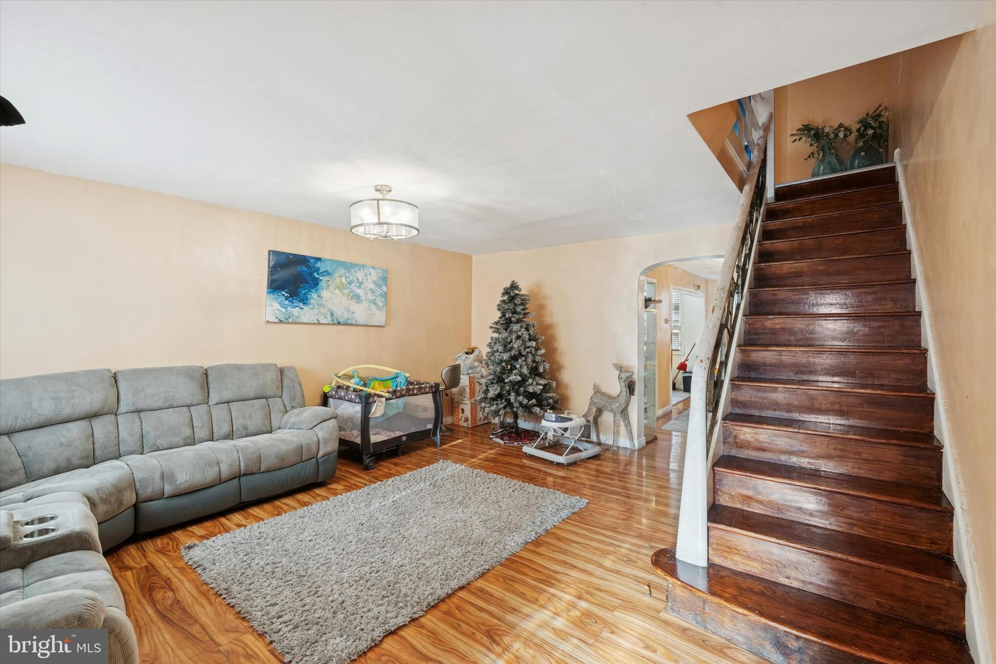 213 East Claremont Road Philadelphia, PA 19120 - Photo 2 of 25 a living room with furniture and wooden floor