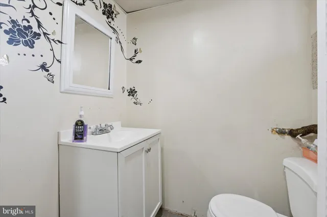 a bathroom with a sink toilet and a mirror