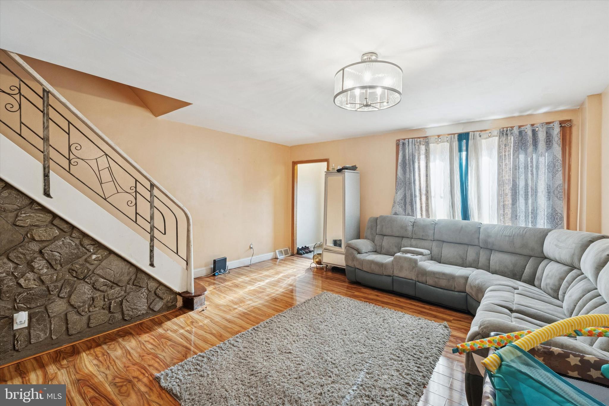 213 East Claremont Road Philadelphia, PA 19120 - Photo 3 of 25 a living room with furniture and wooden floor