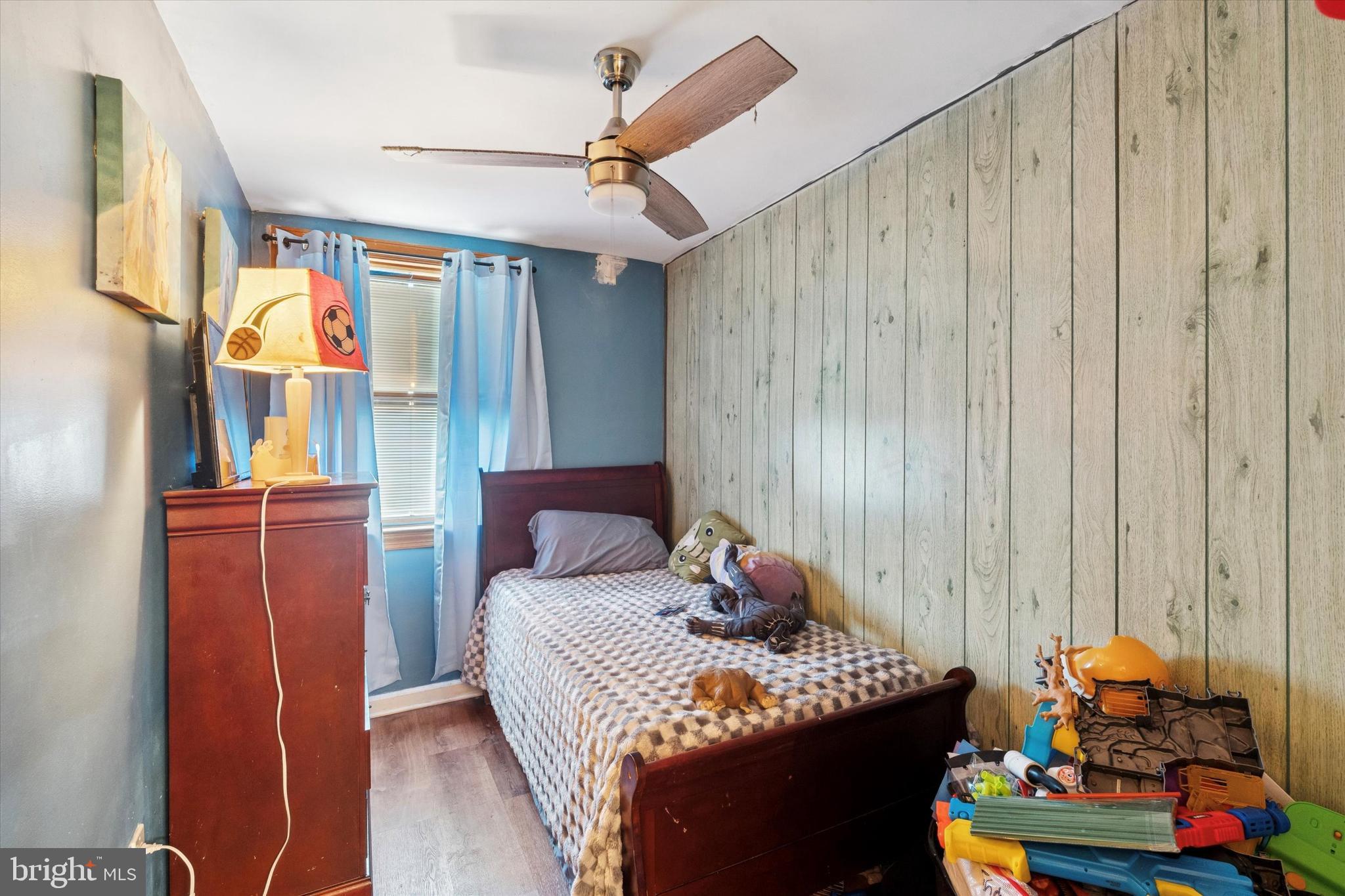 213 East Claremont Road Philadelphia, PA 19120 - Photo 9 of 25 a bedroom with a bed and wooden floor