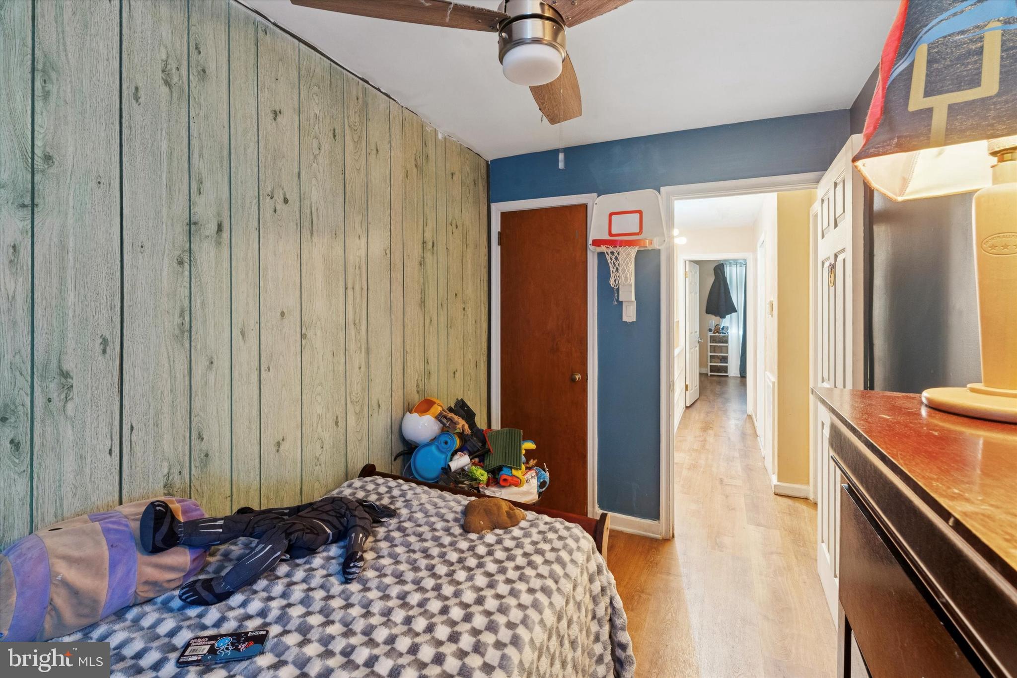 213 East Claremont Road Philadelphia, PA 19120 - Photo 10 of 25 a bedroom with a bed and wooden floor