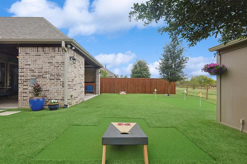 1601 Twistleaf Road Flower Mound, TX 76226 - Photo 12 of 39 a backyard of a house with table and chairs