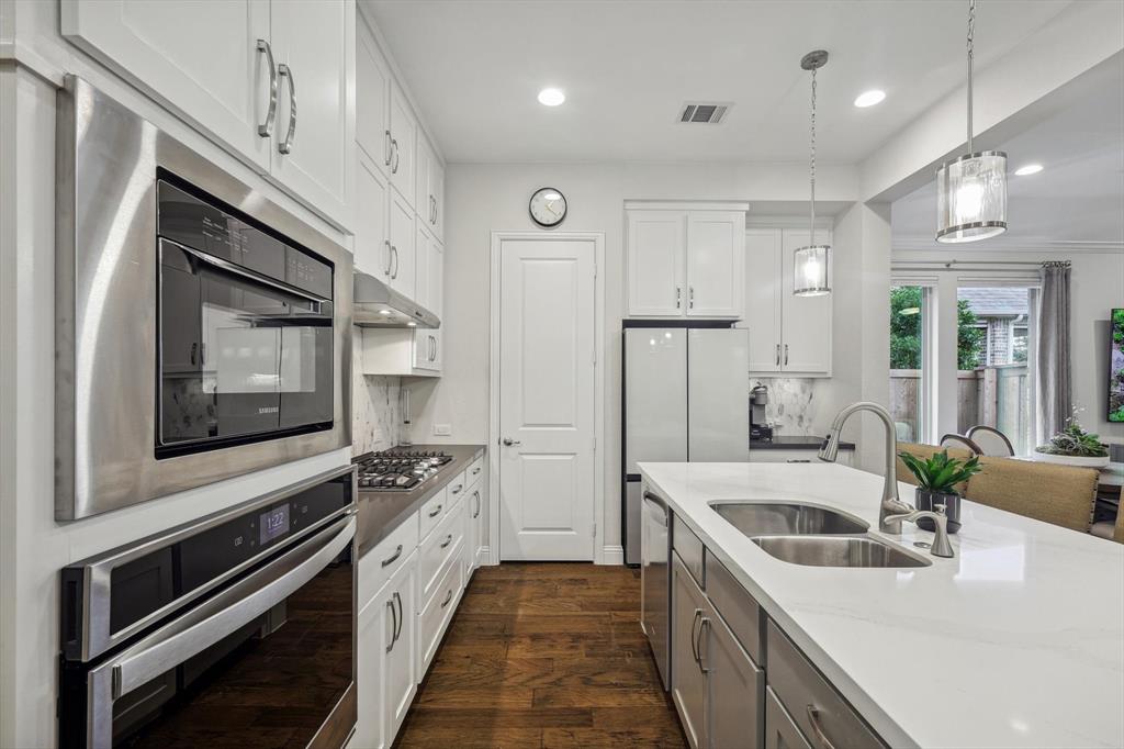 1601 Twistleaf Road Flower Mound, TX 76226 - Photo 16 of 39 a kitchen with stainless steel appliances granite countertop a sink and a stove top oven