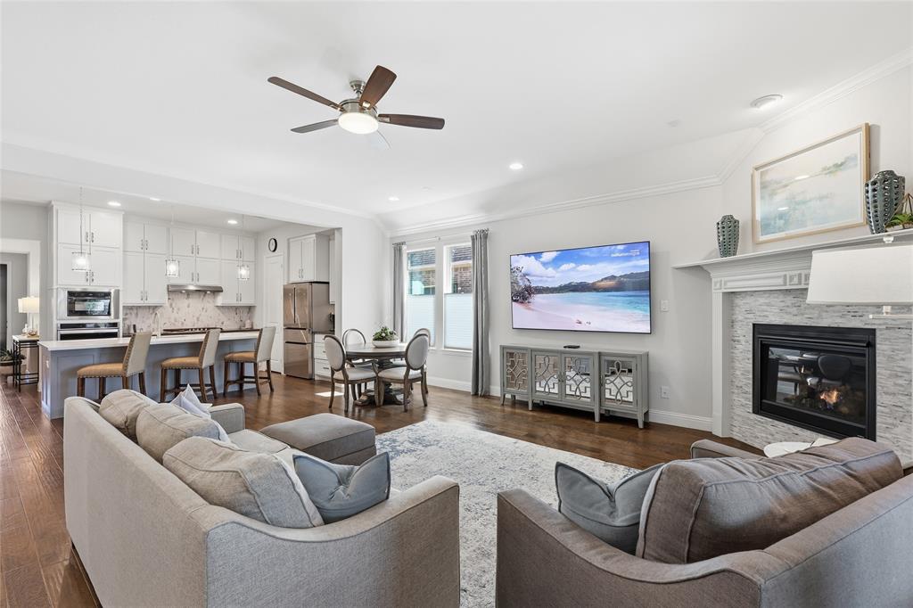 1601 Twistleaf Road Flower Mound, TX 76226 - Photo 25 of 39 a living room with furniture kitchen view and a fireplace