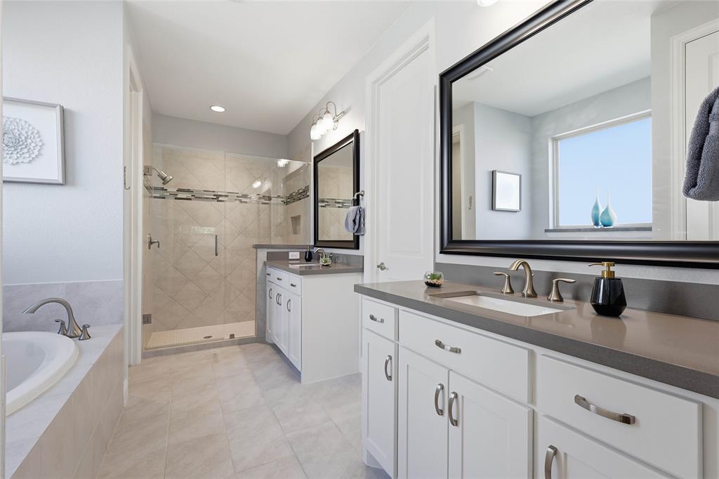 1601 Twistleaf Road Flower Mound, TX 76226 - Photo 29 of 39 a bathroom with a granite countertop sink mirror and bathtub
