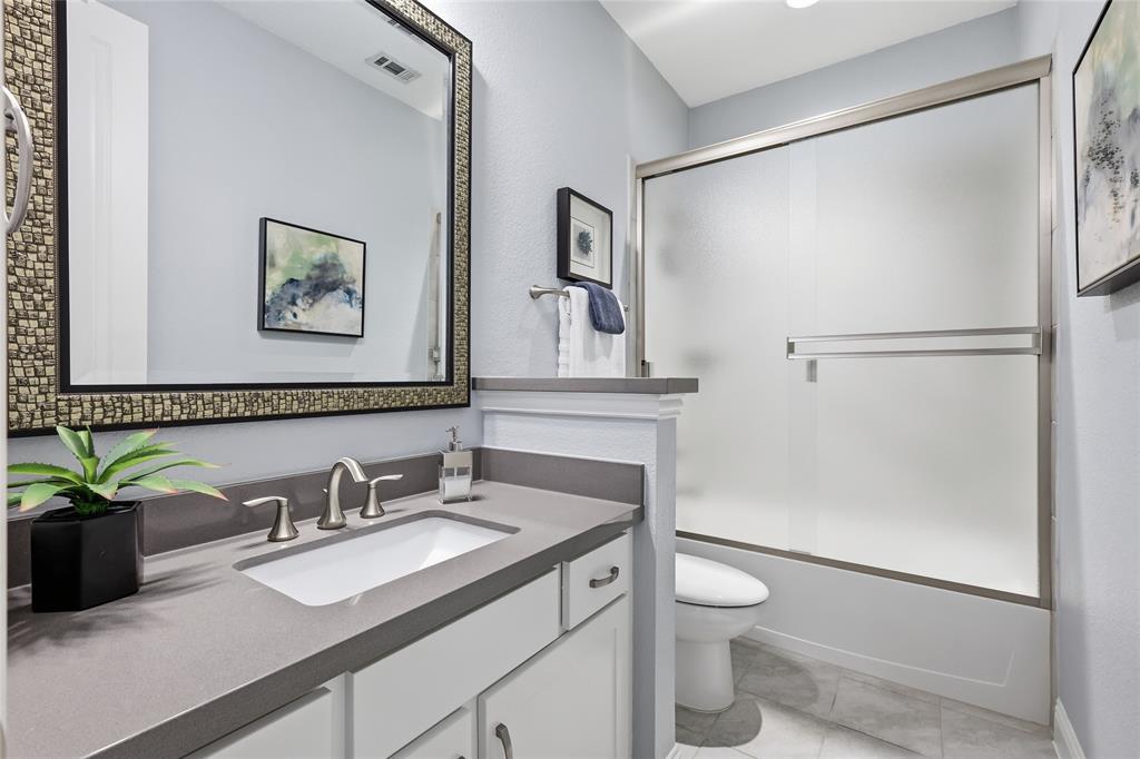 1601 Twistleaf Road Flower Mound, TX 76226 - Photo 31 of 39 a bathroom with a granite countertop sink toilet and shower
