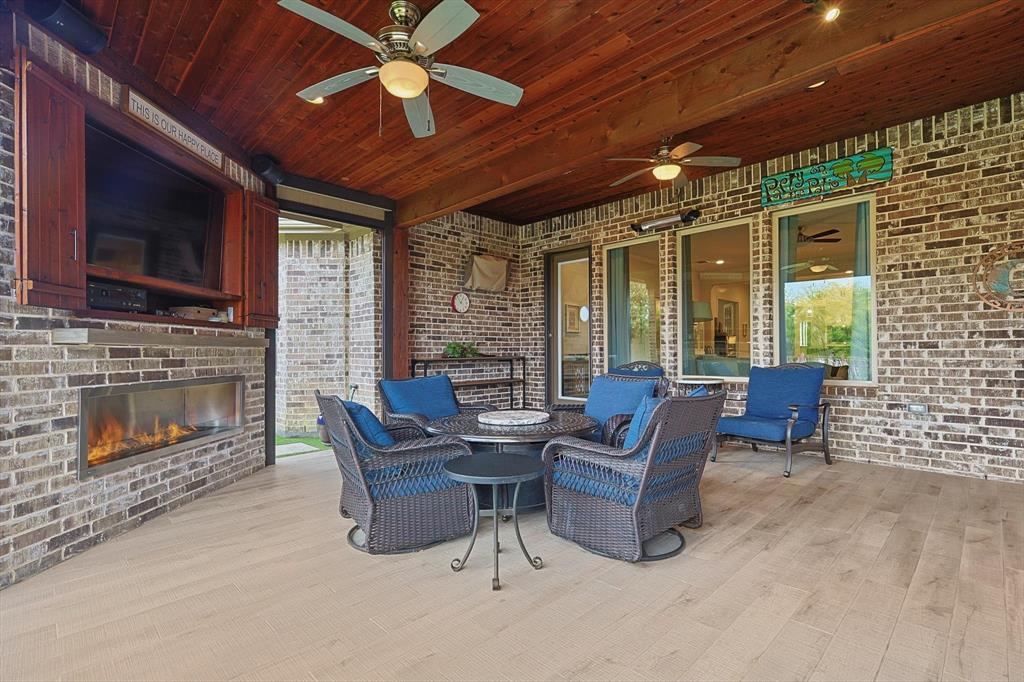 1601 Twistleaf Road Flower Mound, TX 76226 - Photo 5 of 39 a living room with furniture a flat screen tv and a fireplace