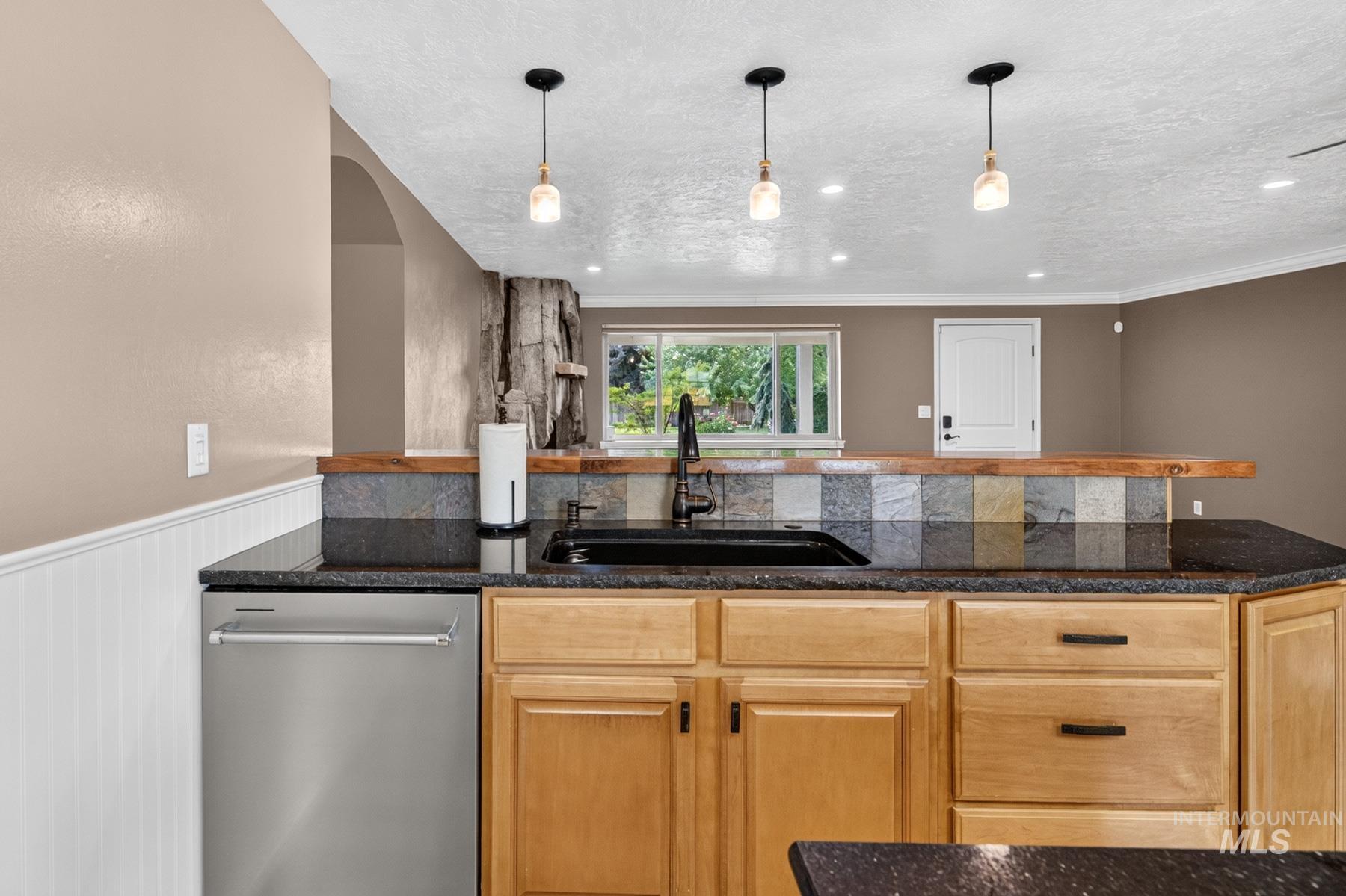 9622 Delaware Street Boise, ID 83709 - Photo 16 of 48 Kitchenette featuring a stainless steel dishwasher, black granite countertops, wood cabinetry, and a black sink with a matte black faucet