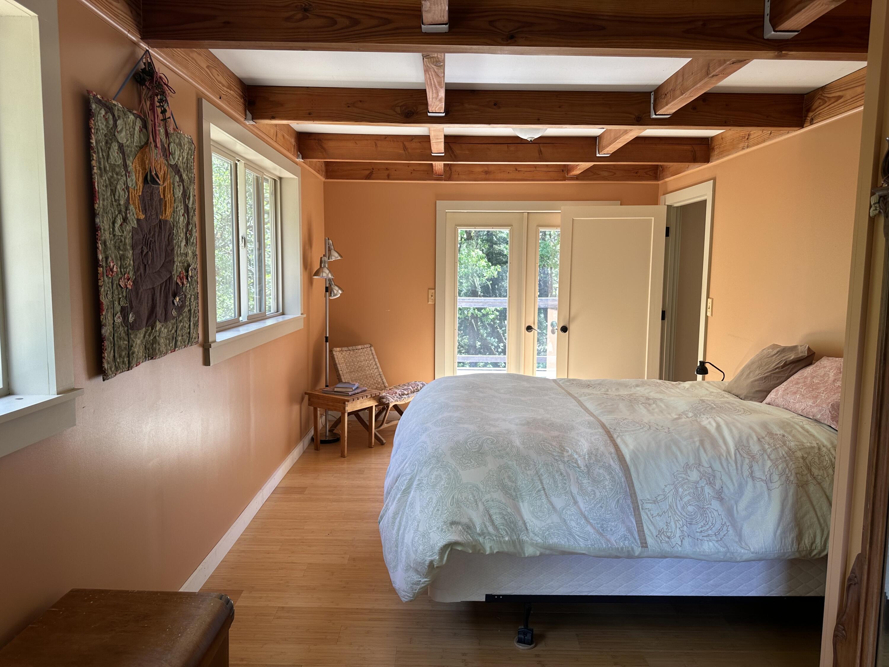 83000 Milstead Road Garberville, CA 95542 - Photo 22 of 67 a bedroom with a bed and wooden floor
