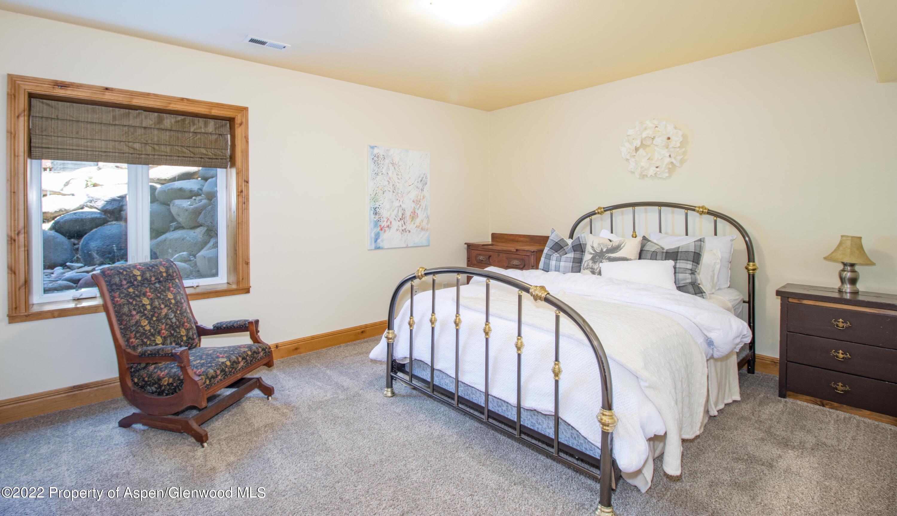 323 Faas Ranch Road New Castle, CO 81647 - Photo 19 of 22 a spacious bedroom with a bed and a window