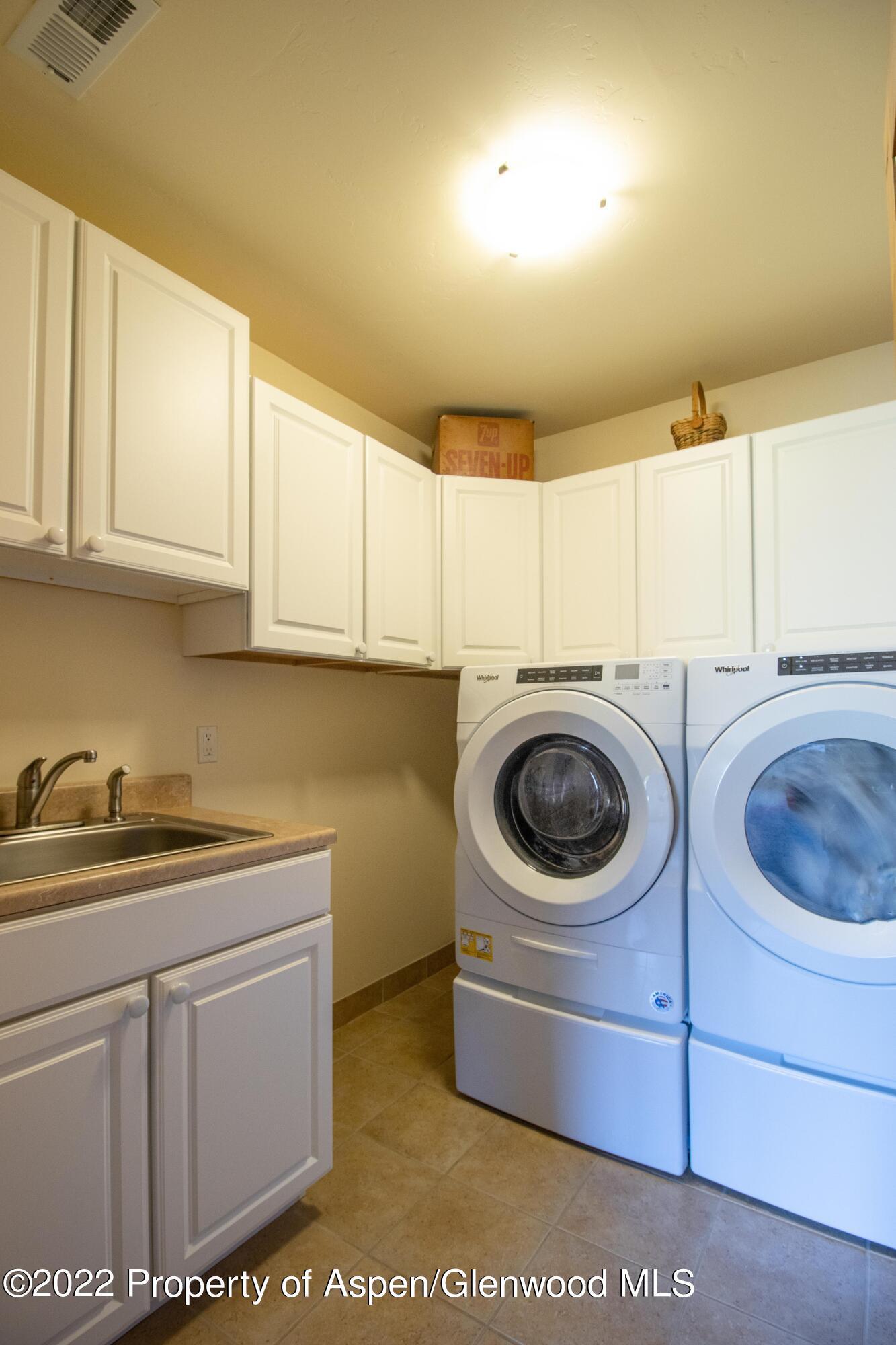 323 Faas Ranch Road New Castle, CO 81647 - Photo 22 of 22 a utility room with sink dryer and washer