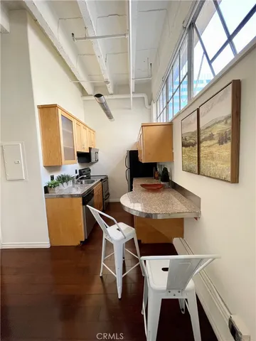 a dining room with a table chairs and a kitchen view