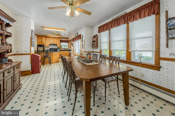 a dining table with chairs and window