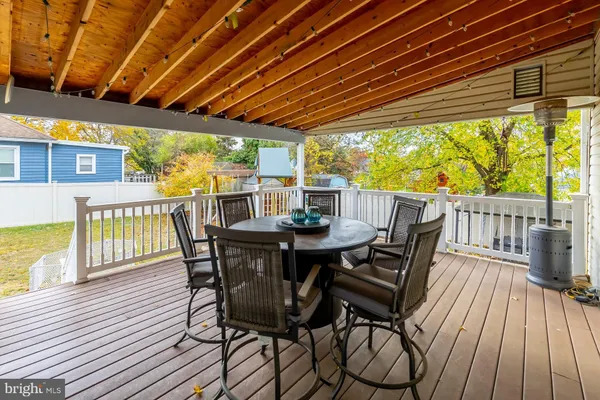 a view of a patio with a table chairs and wooden floor
