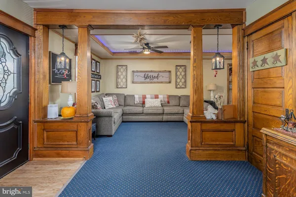 a living room with furniture and a chandelier