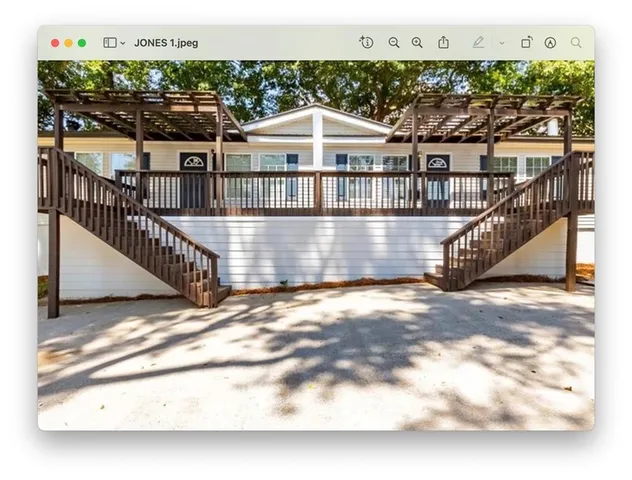 a view of a house with a wooden deck
