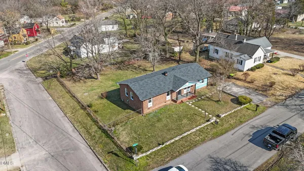 an aerial view of a house with a yard