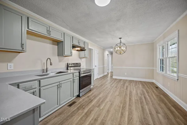 a kitchen with a sink stainless steel appliances and cabinets