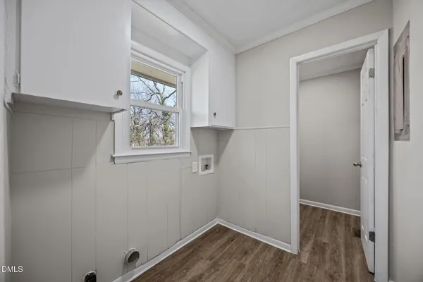 a view of small space with wooden floor and a window