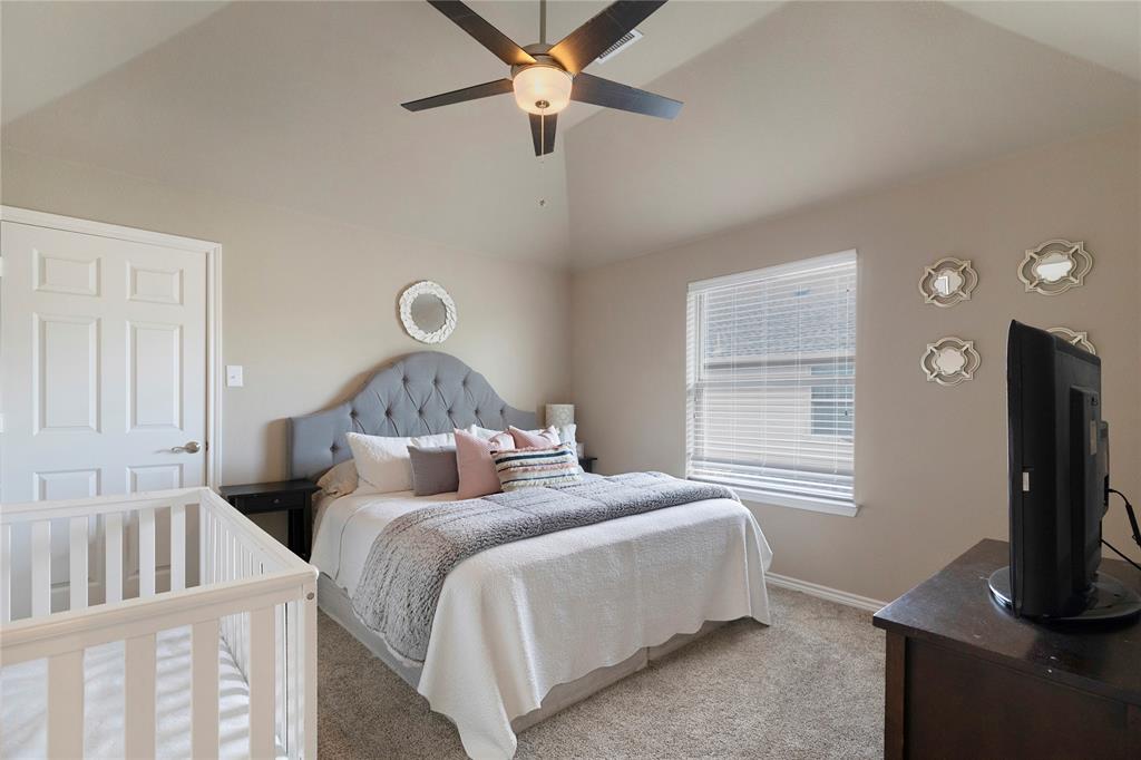 11604 Compton Trail Fort Worth, TX 76244 - Photo 25 of 40 a bedroom with a bed and a flat tv screen on dresser