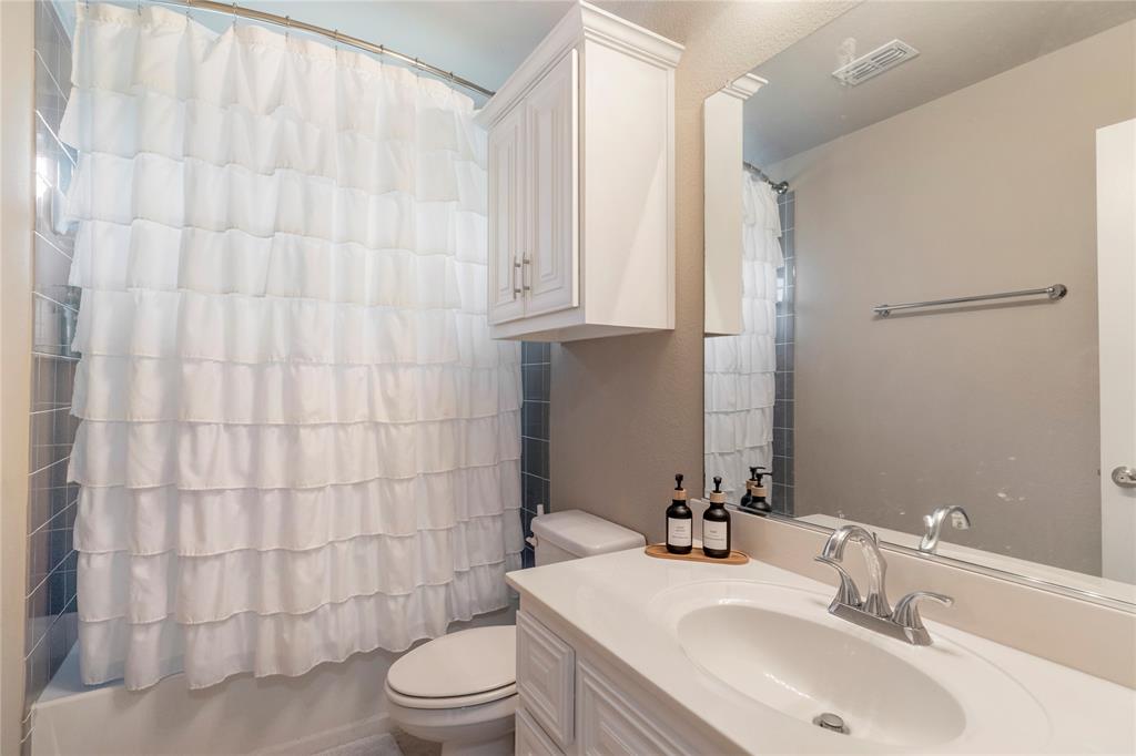 11604 Compton Trail Fort Worth, TX 76244 - Photo 27 of 40 a bathroom with a sink a toilet and shower curtain