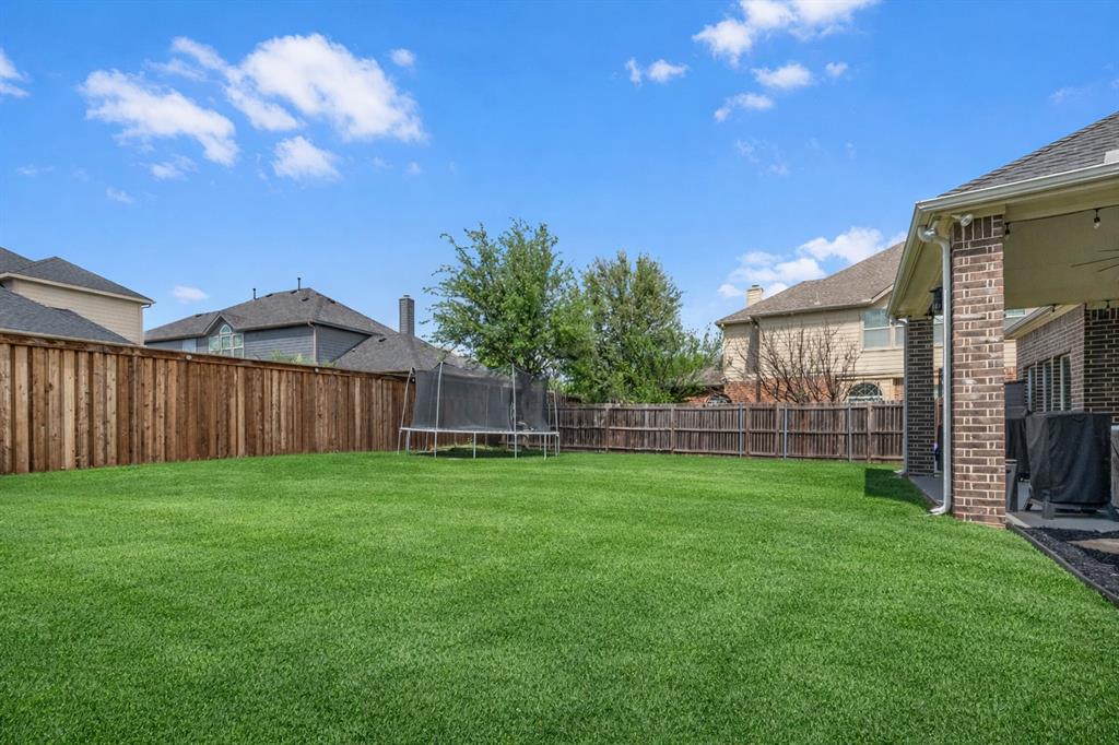 11604 Compton Trail Fort Worth, TX 76244 - Photo 36 of 40 a view of a backyard with potted plants and wooden fence