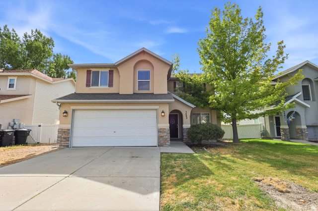 5485 Heather Way Tooele, UT 84074 - Photo 9 of 41 Two-story residence featuring a two-car garage, stone accents, and a covered entry