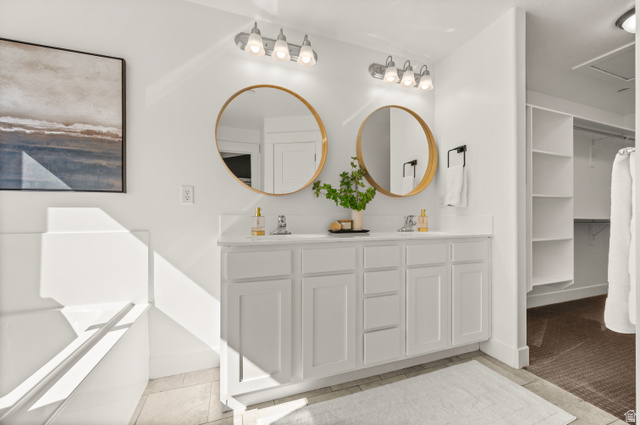 14728 South Canyon Pointe Road Draper, UT 84020 - Photo 17 of 35 Dual vanity featuring white shaker cabinetry, an integrated white countertop, and two round framed mirrors with vanity lighting