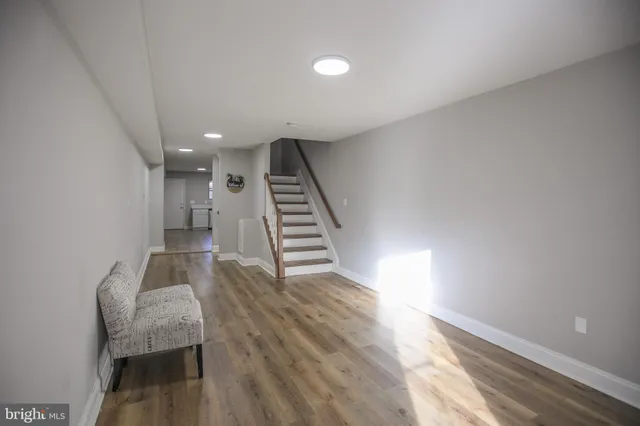 a view of a hallway with wooden floor