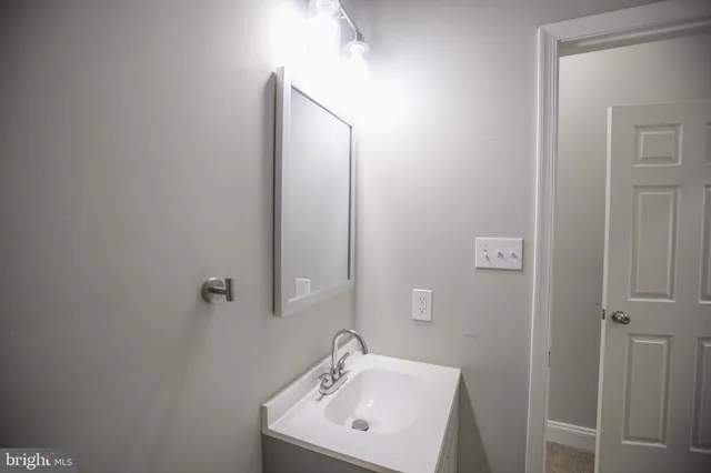 a white toilet sitting next to a bathroom sink