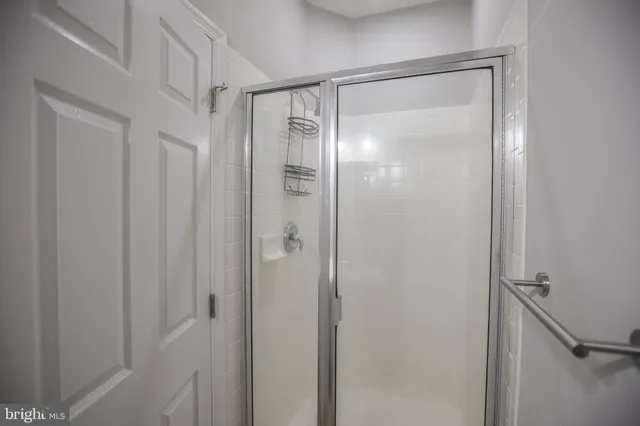 a bathroom with a shower and a bath tub