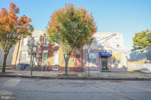 a kitchen with a refrigerator a table and chairs