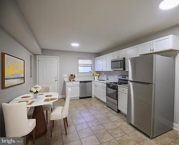 a kitchen with a sink stainless steel appliances and cabinets