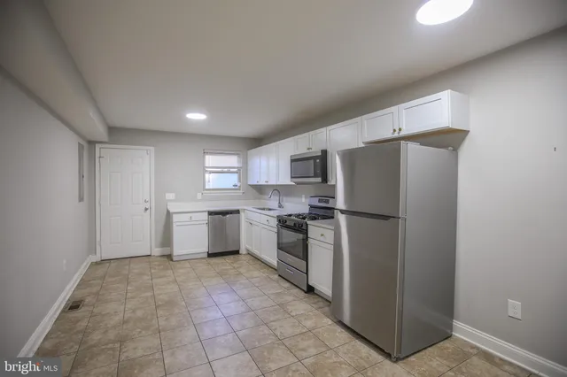 a kitchen with a sink a stove and microwave