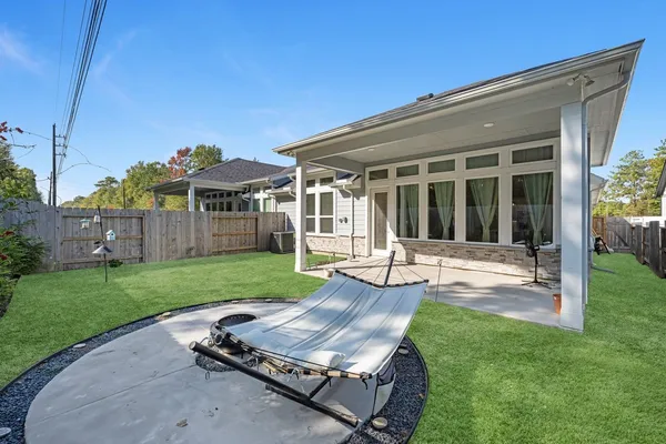front view of a house with a yard table and chairs