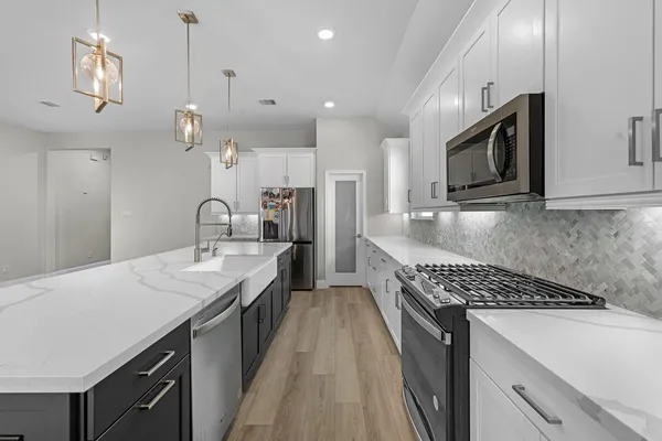a kitchen with counter top space cabinets and stainless steel appliances
