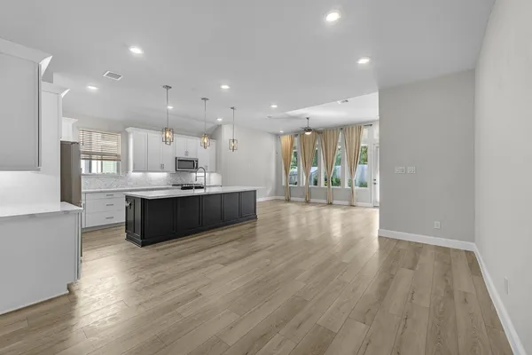 a large kitchen with a large counter top appliances and cabinets