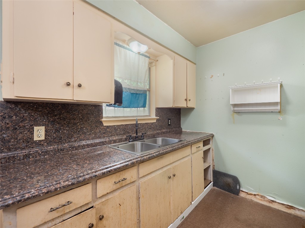 1021 Gardner Road Austin, TX 78721 - Photo 11 of 31 a kitchen with granite countertop white cabinets and sink