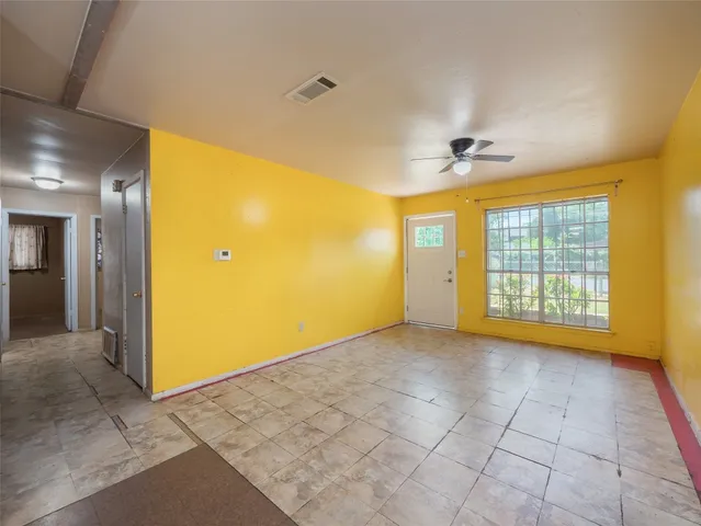 a view of an empty room with glass door
