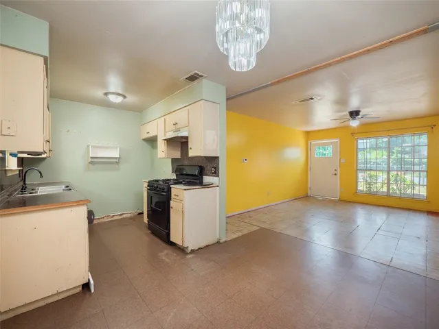 a kitchen with a stove a refrigerator and a sink