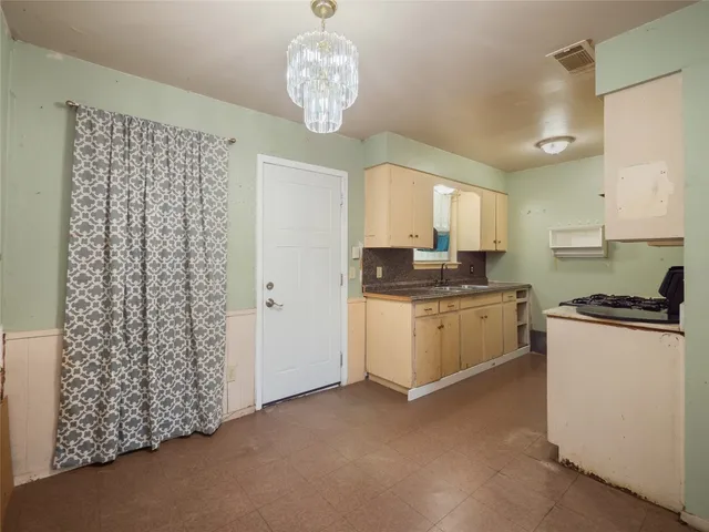 a kitchen with a refrigerator a stove a sink and a window
