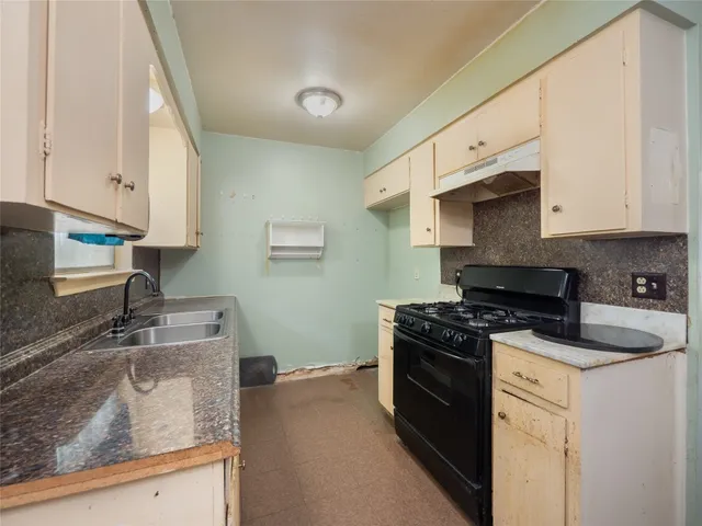 a kitchen with stainless steel appliances granite countertop a sink stove and cabinets