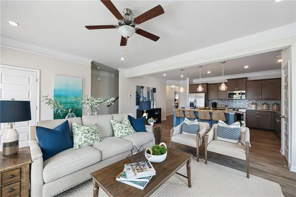 a view of a living room or kitchen and a dining table with wooden floor