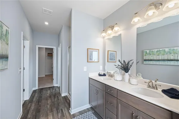 a bathroom with a double vanity sink and a mirror