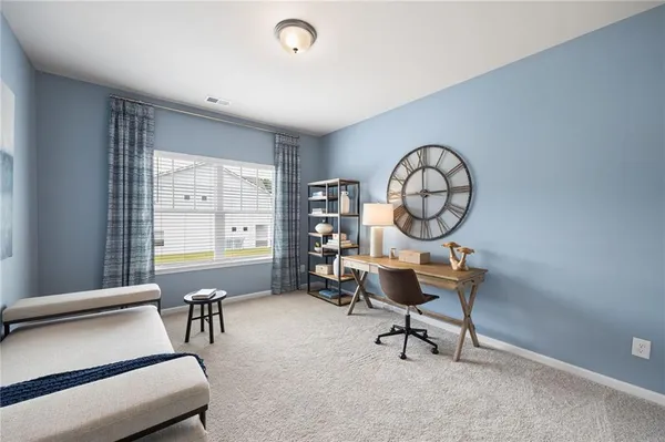 a living room with furniture a clock and a large window
