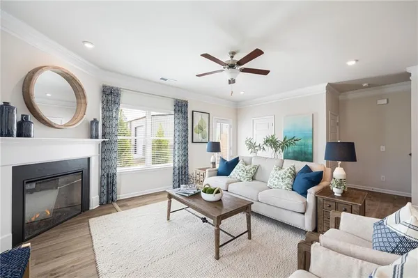 a living room with furniture a fireplace and a large window