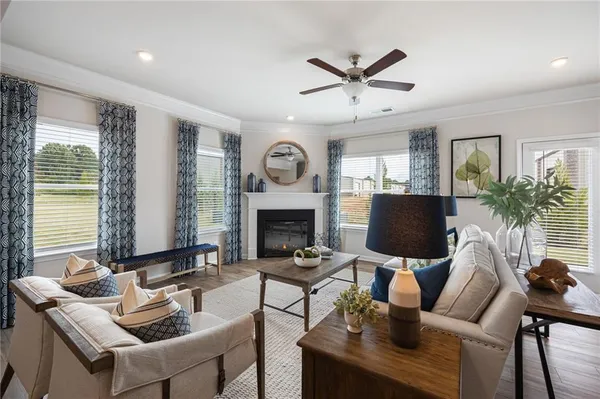 a living room with furniture a fireplace and a window